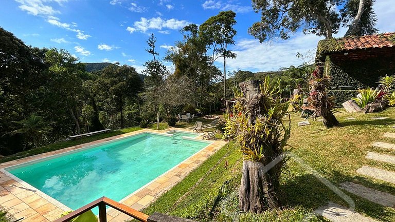 Refúgio com piscina, lareira e vista para o jardim